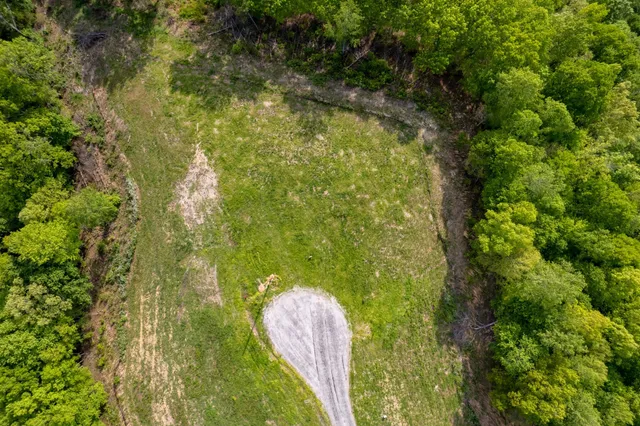 a aerial view of a residential houses with yard
