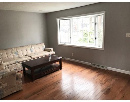 31 Dingwell Street Lowell, MA 01851 - Photo 2 of 9 a bedroom with bed and a window