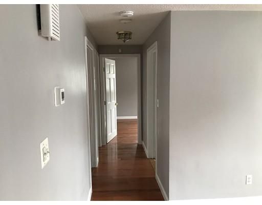 31 Dingwell Street Lowell, MA 01851 - Photo 5 of 9 a view of a hallway with wooden floor