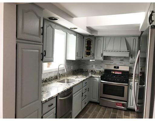 31 Dingwell Street Lowell, MA 01851 - Photo 6 of 9 a kitchen with granite countertop a stove sink and refrigerator