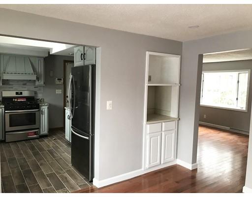 31 Dingwell Street Lowell, MA 01851 - Photo 7 of 9 a view of a kitchen from the hallway