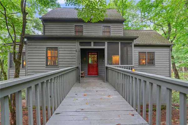a view of a house with wooden fence