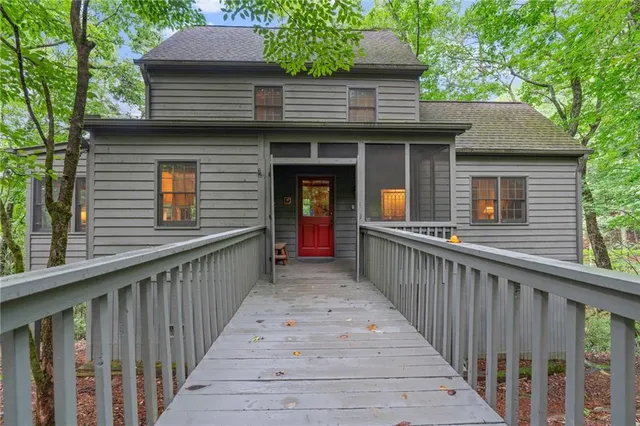 a view of a house with wooden fence