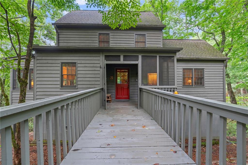 a view of a house with wooden fence