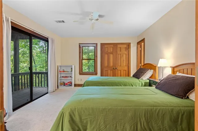 a bedroom with a large bed and a large window