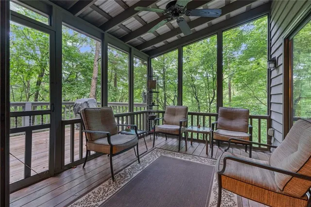 a living room with furniture and a floor to ceiling window