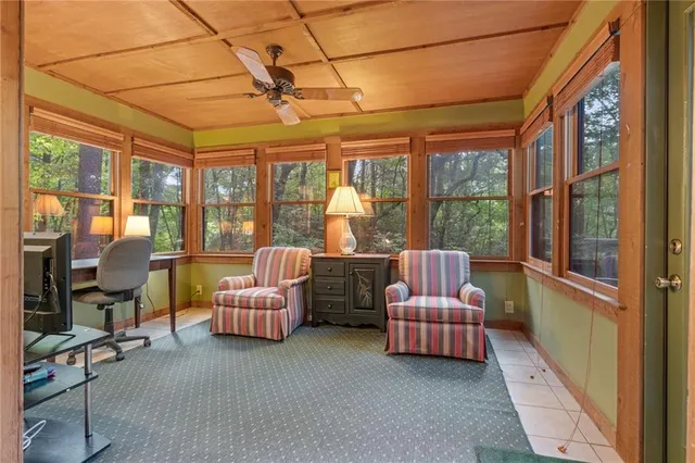 a living room with furniture and large windows