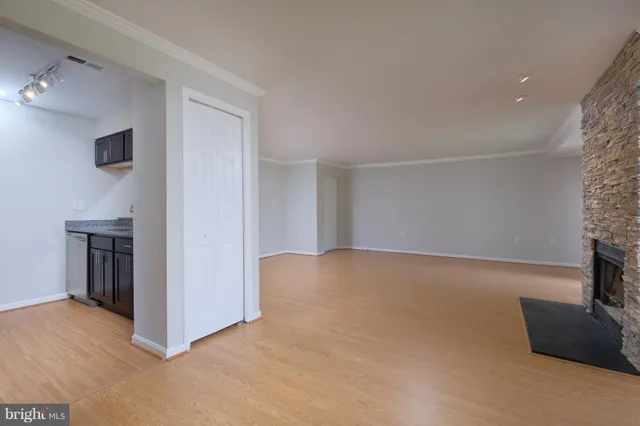 a kitchen with stainless steel appliances granite countertop a refrigerator and a stove