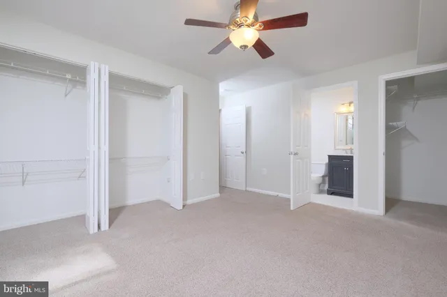 a view of a hallway with closet and wooden floor