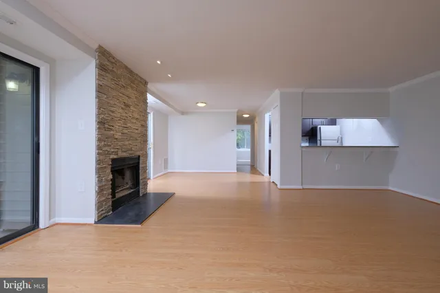 a view of a kitchen with a sink and a fireplace