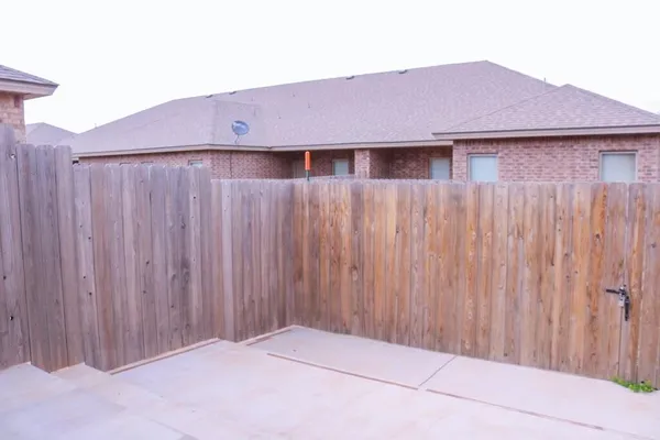 a view of a house with wooden fence