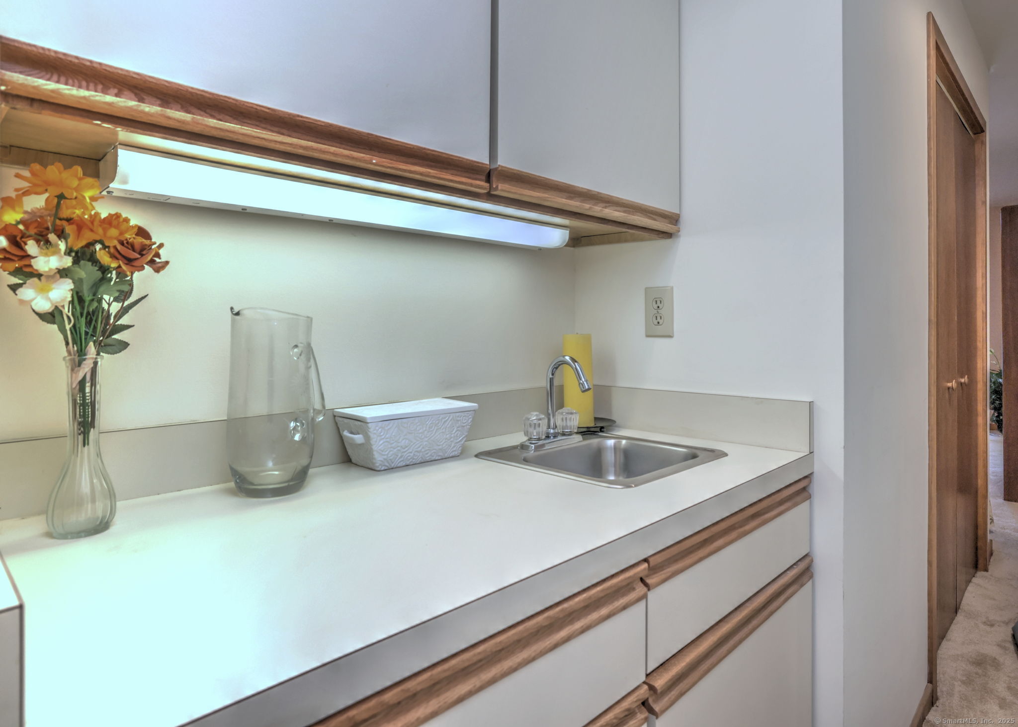 690 Forest Road, Unit 702 West Haven, CT 06516 - Photo 18 of 40 a kitchen with a sink and a cabinets