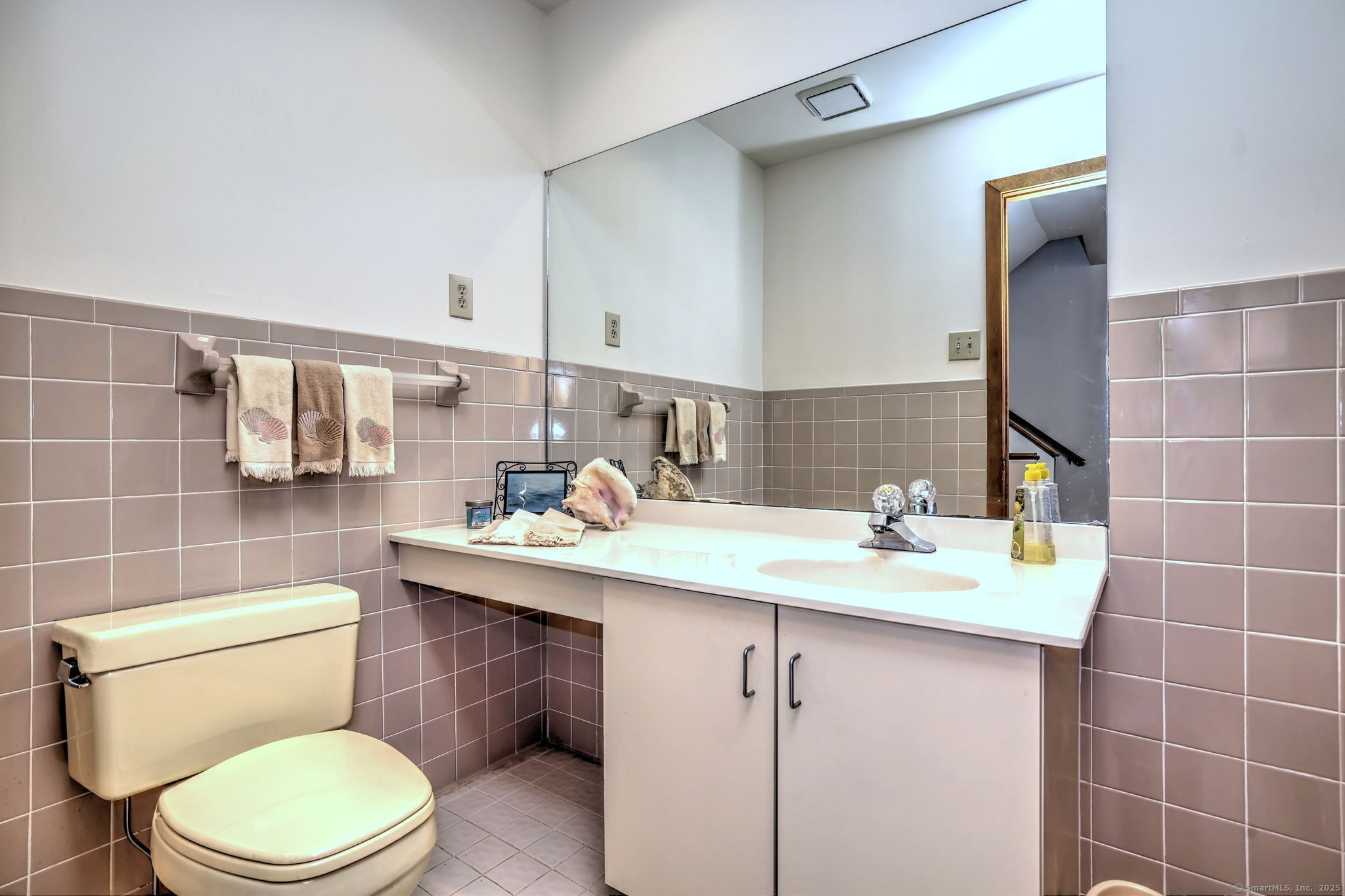 690 Forest Road, Unit 702 West Haven, CT 06516 - Photo 31 of 40 a bathroom with a sink a toilet and mirror