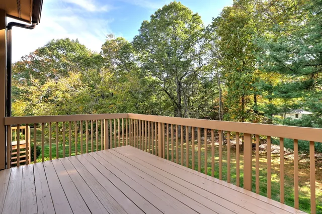 a balcony with wooden floor and fence