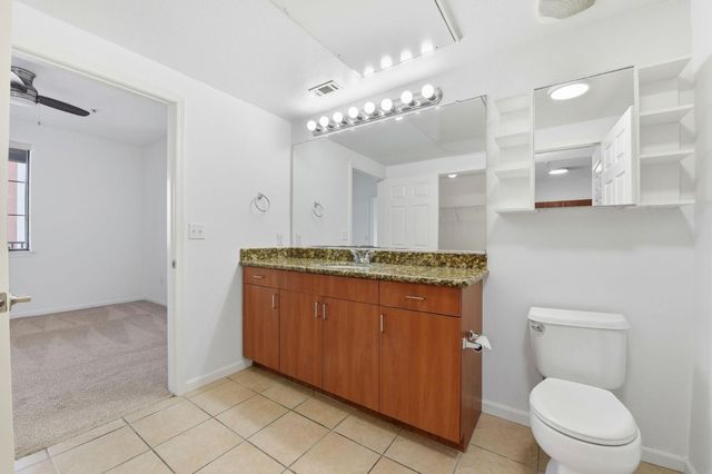 a view of a kitchen cabinets and a hallway with wooden floor
