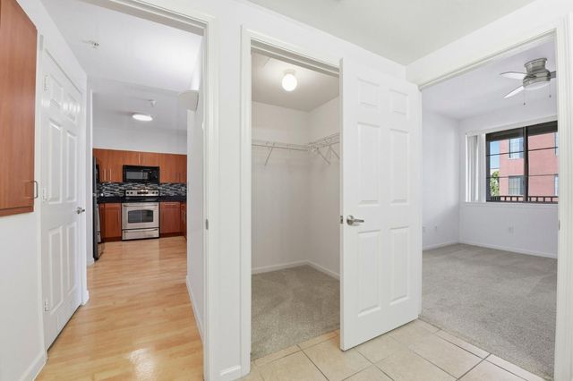 a view of a closet area with wooden floor