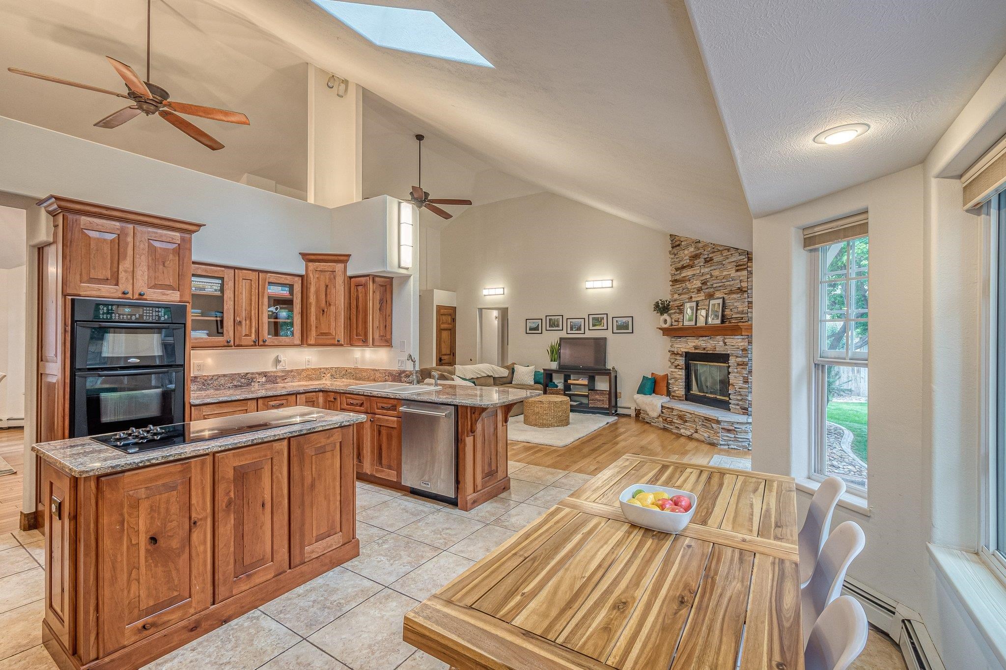 2321 South Rim Drive Grand Junction, CO 81507 - Photo 15 of 41 a kitchen with stainless steel appliances granite countertop a stove top oven a sink dishwasher and cabinets with wooden floor