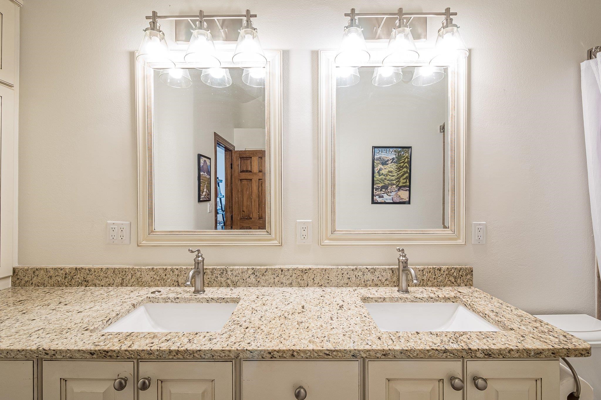 2321 South Rim Drive Grand Junction, CO 81507 - Photo 21 of 41 a bathroom with a granite countertop sink and a mirror
