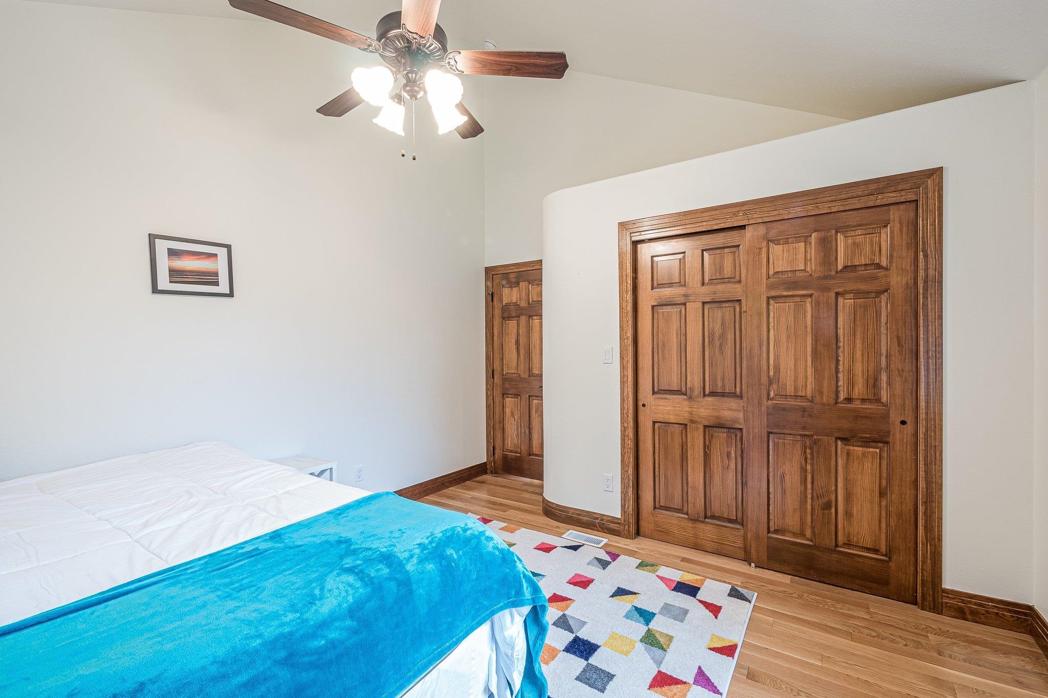 2321 South Rim Drive Grand Junction, CO 81507 - Photo 23 of 41 a bedroom with a bed and a chandelier fan