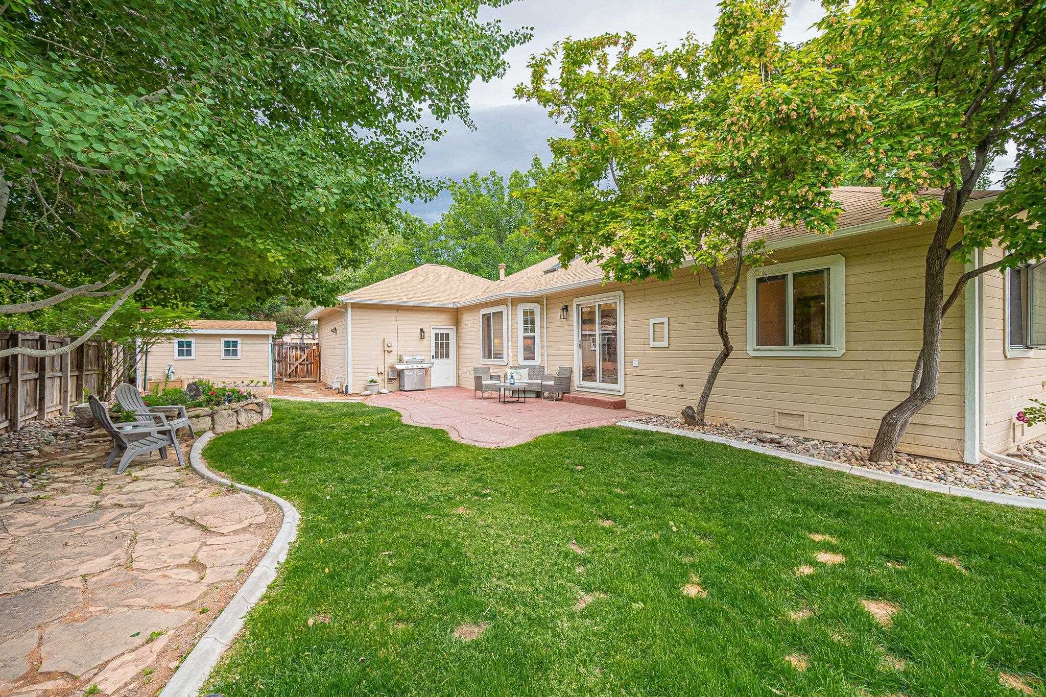 2321 South Rim Drive Grand Junction, CO 81507 - Photo 37 of 41 a view of a house with a yard and a patio