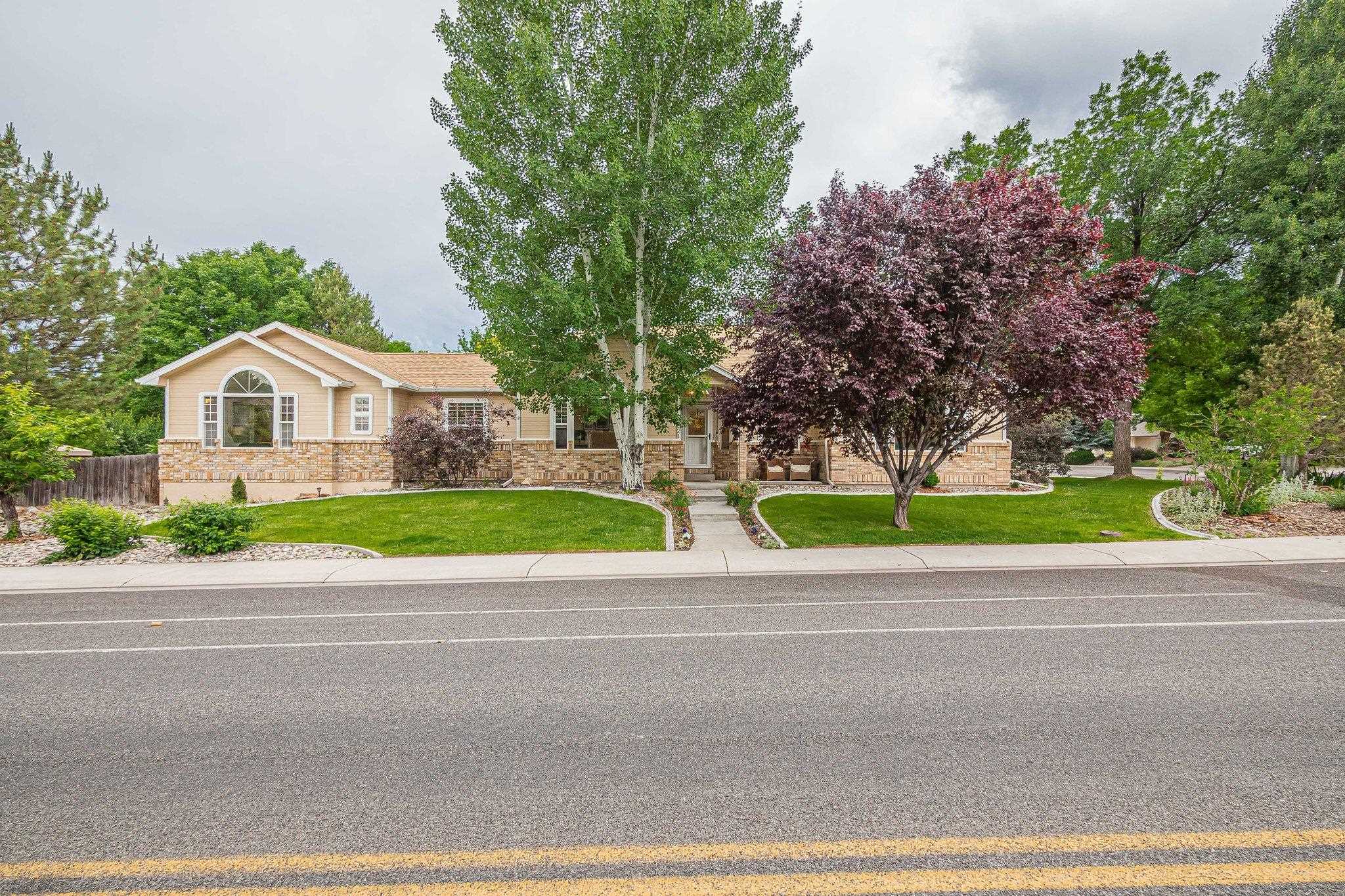 2321 South Rim Drive Grand Junction, CO 81507 - Photo 4 of 41 a view of a house with a yard and large trees