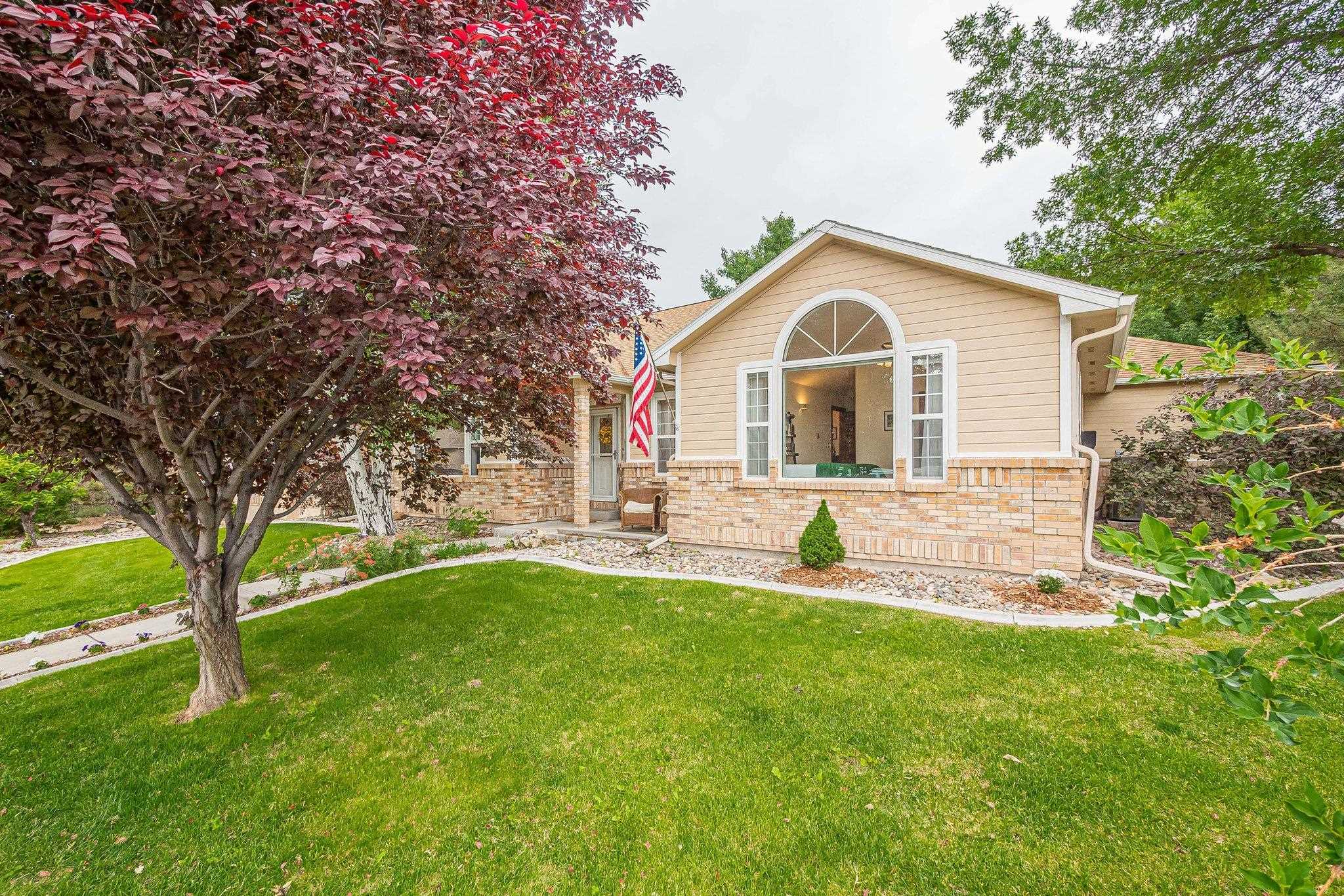 2321 South Rim Drive Grand Junction, CO 81507 - Photo 5 of 41 a front view of a house with a yard and trees