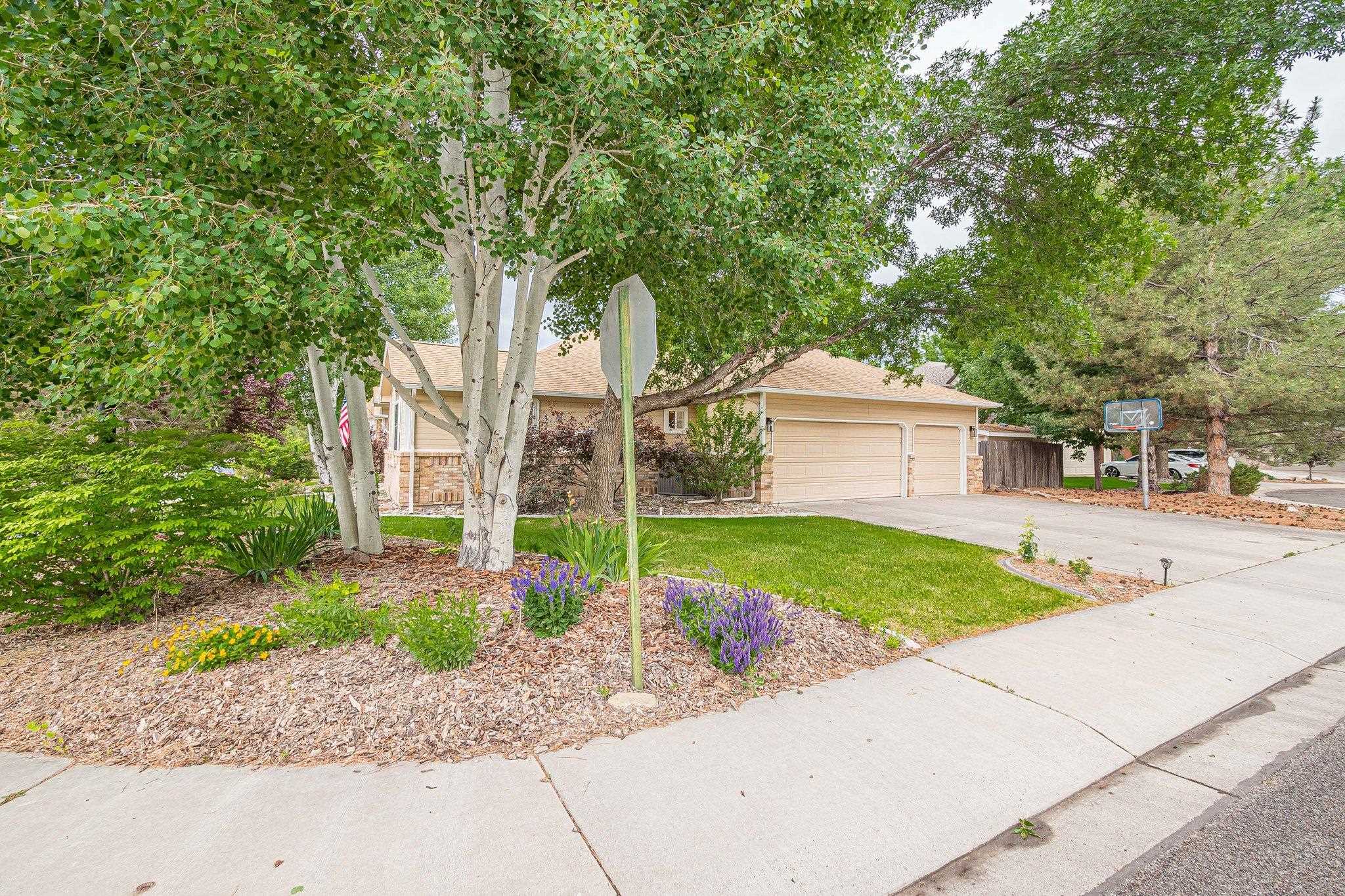 2321 South Rim Drive Grand Junction, CO 81507 - Photo 6 of 41 a front view of a house with a yard and a garage
