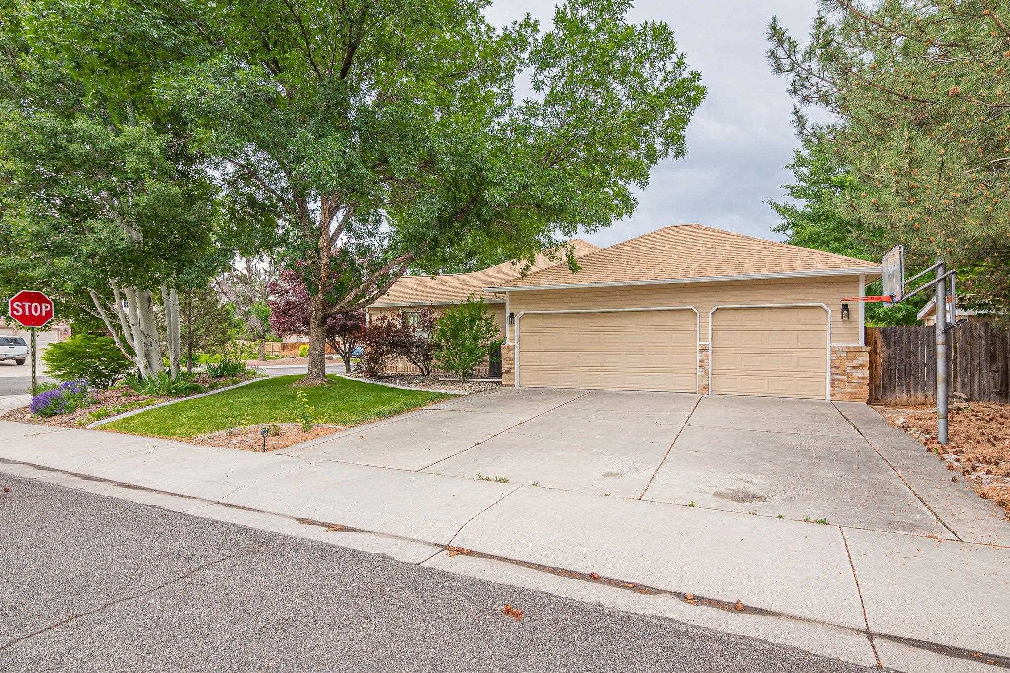 2321 South Rim Drive Grand Junction, CO 81507 - Photo 7 of 41 a front view of a house with a yard and garage