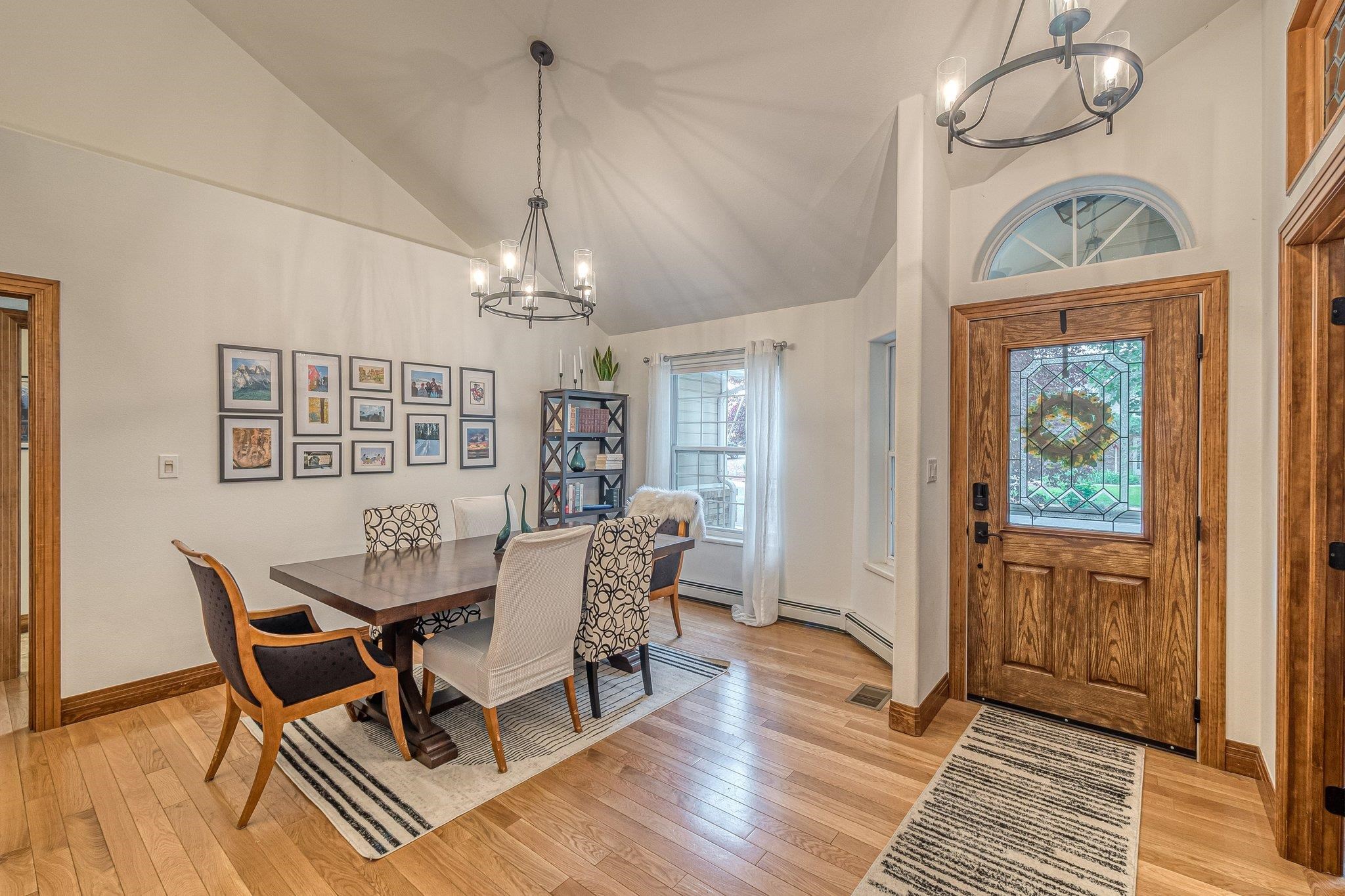 2321 South Rim Drive Grand Junction, CO 81507 - Photo 9 of 41 a dining room with wooden floor a chandelier a wooden table and chairs
