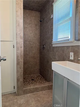 a bathroom with a sink a shower and a mirror