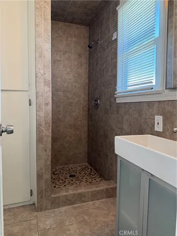 a bathroom with a sink a shower and a mirror