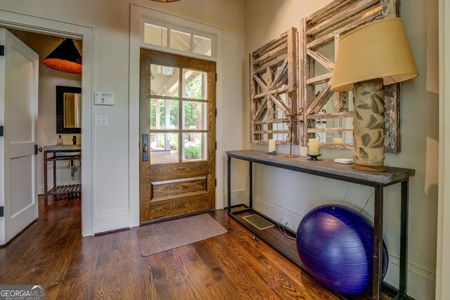 a kitchen with a stove and a wooden floor