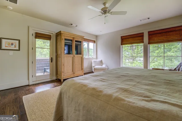 a view of a hallway with wooden floor and living room