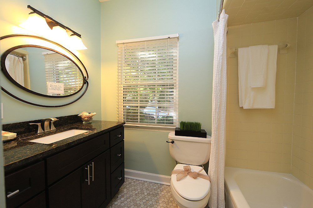 6579 New Market Way, Unit 6579 Raleigh, NC 27615 - Photo 18 of 22 Main Floor Totally Renovated Master Bath. New Honeycomb Tile Floor, New Vanity, New Toilet and Re-Surfaced Bathtub with Lifetime Warranty. Main Floor Full Bath