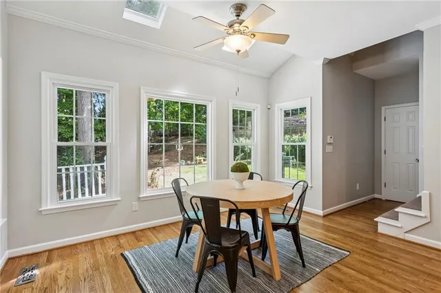 a view of a dining room with furniture window and wooden floor