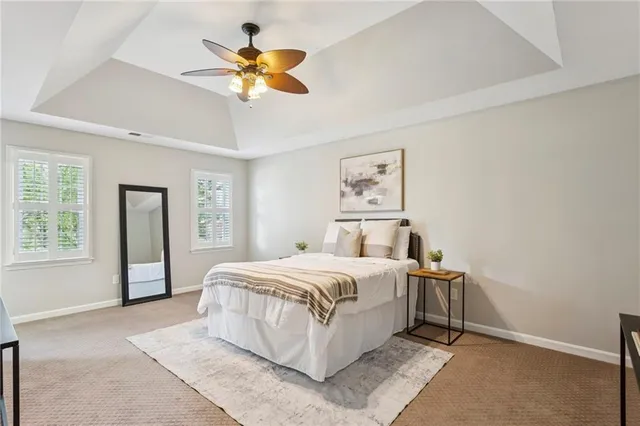 a bedroom with a large bed and a chandelier