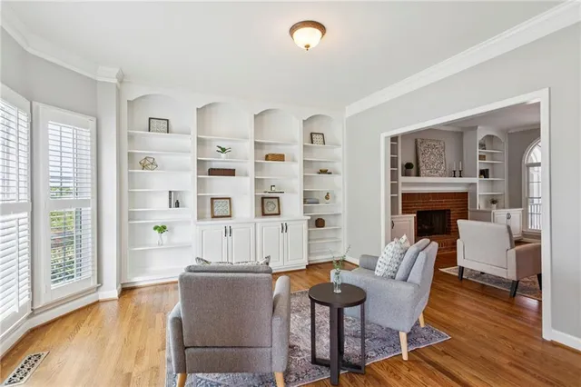 a living room with fireplace furniture and a wooden floor