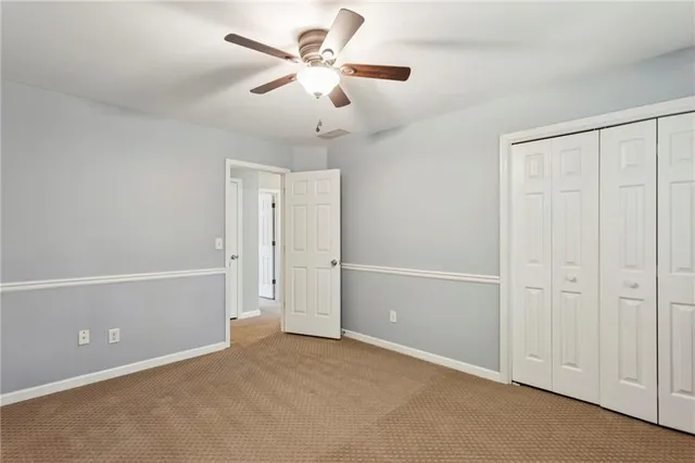 an empty room with a ceiling fan