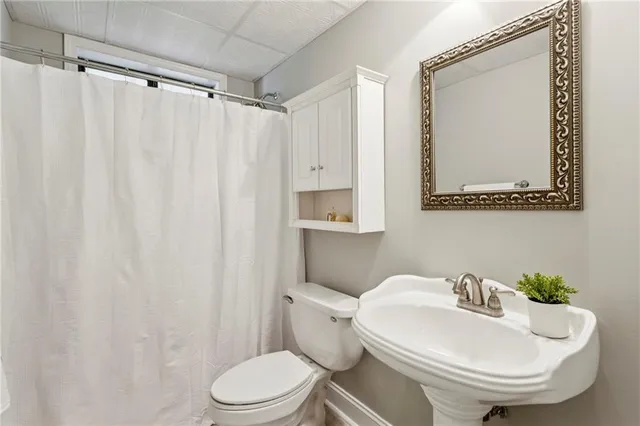 a white toilet sitting next to a bathroom sink