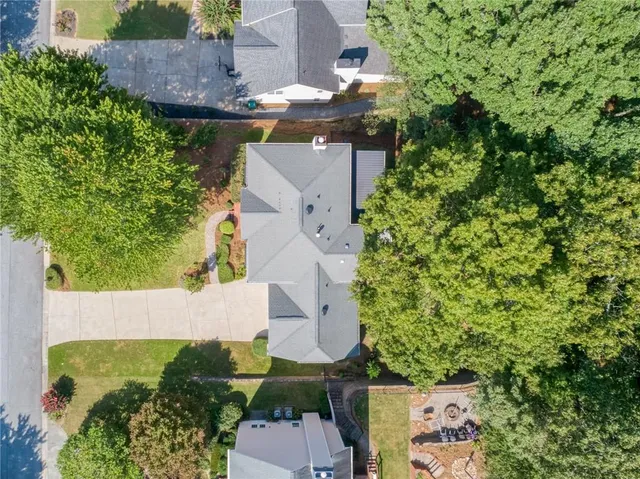 an aerial view of a house with a yard
