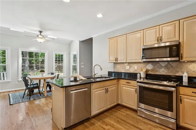 a kitchen with a sink stove and microwave