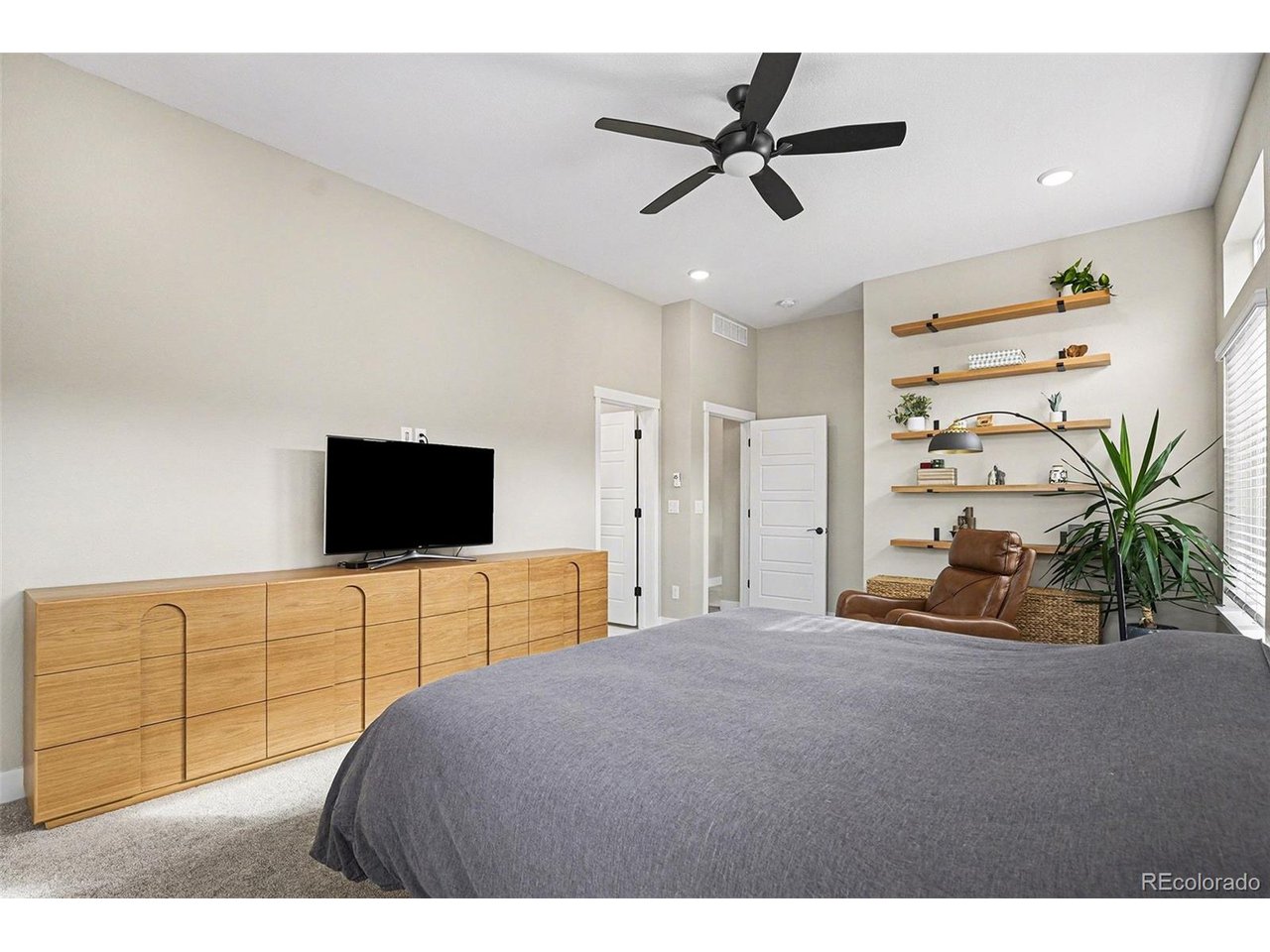 9958 East 63rd Place, Unit 2 Denver, CO 80238 - Photo 12 of 35 a bedroom with a bed and a flat screen tv