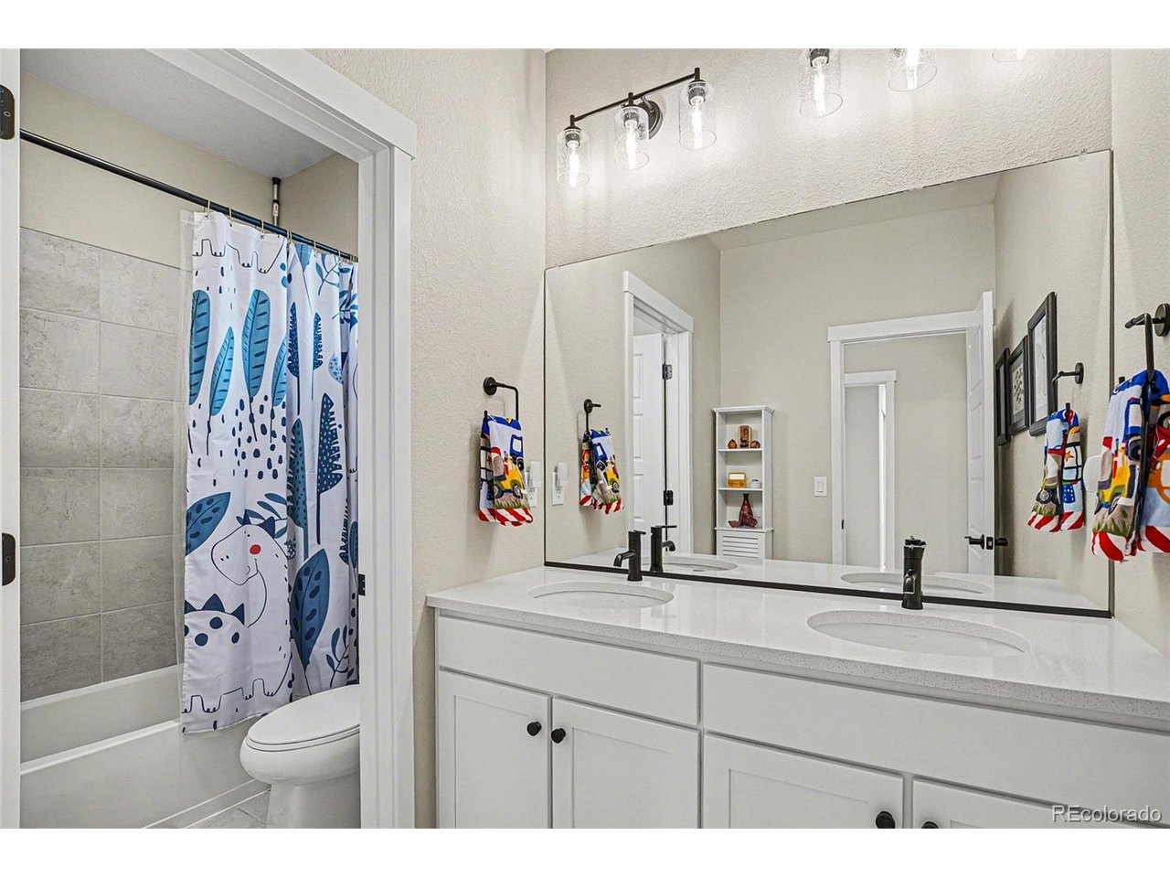 9958 East 63rd Place, Unit 2 Denver, CO 80238 - Photo 16 of 35 a bathroom with a sink and a mirror