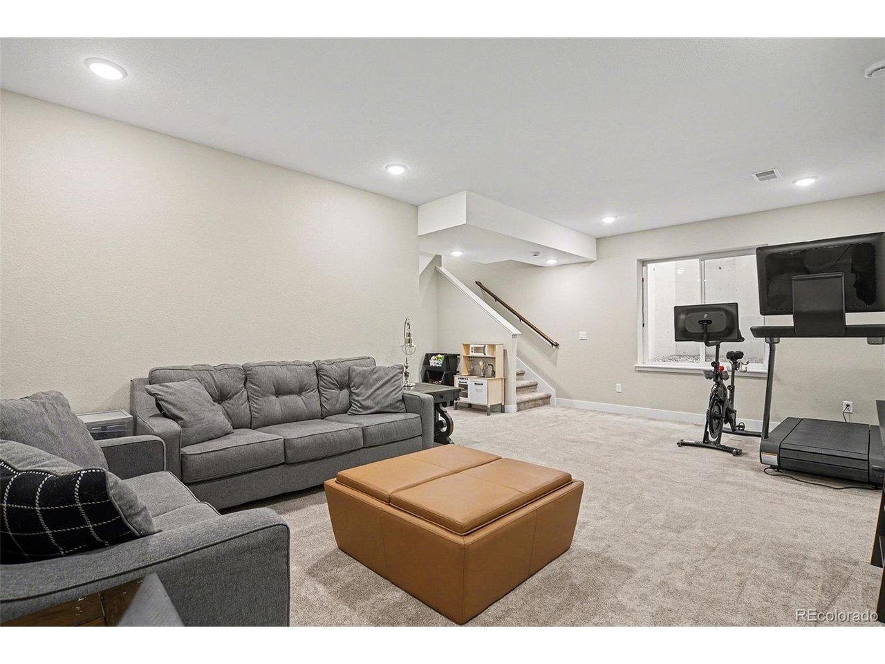 9958 East 63rd Place, Unit 2 Denver, CO 80238 - Photo 21 of 35 a living room with furniture and white kitchen