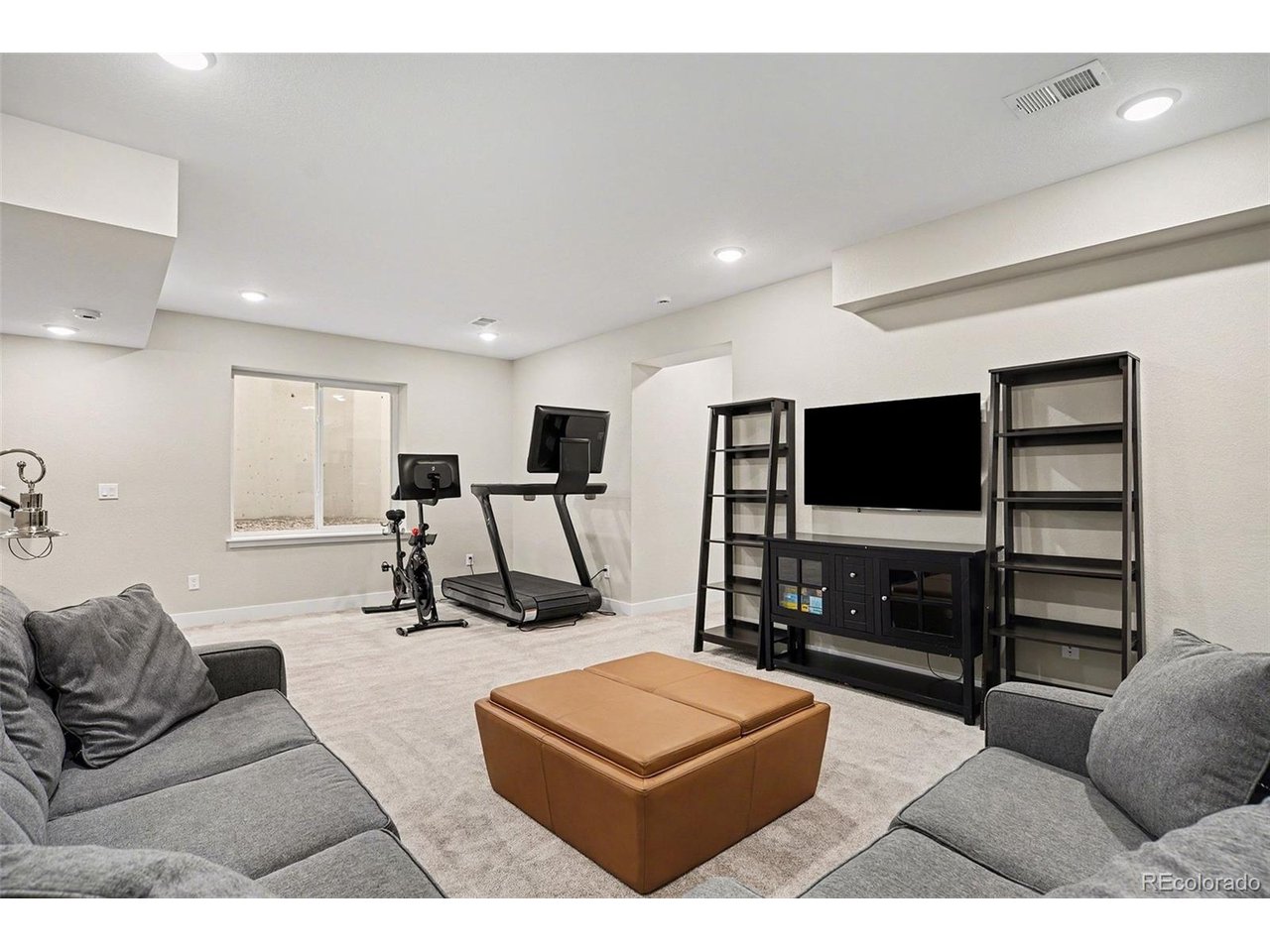 9958 East 63rd Place, Unit 2 Denver, CO 80238 - Photo 22 of 35 a living room with furniture and a flat screen tv
