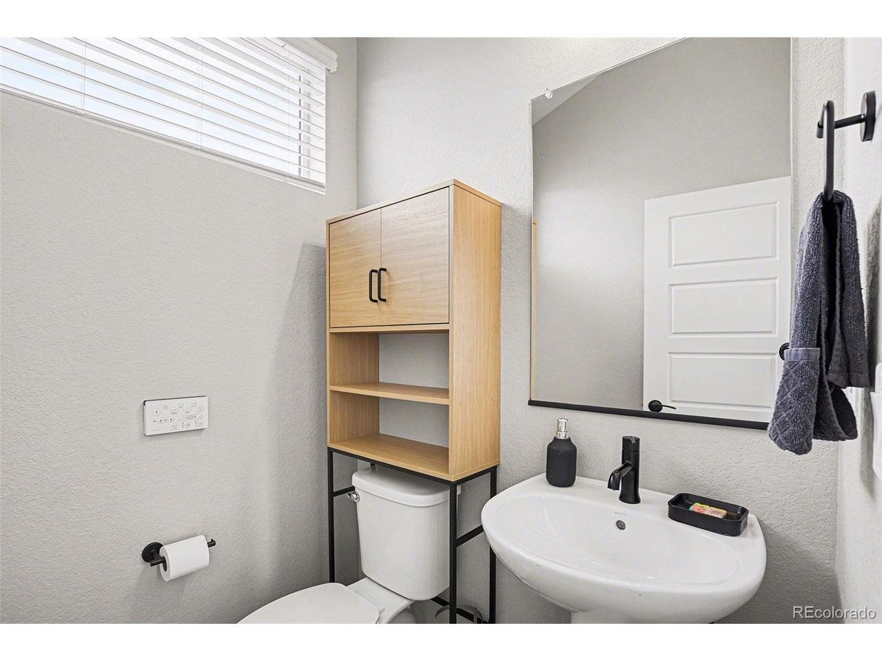 9958 East 63rd Place, Unit 2 Denver, CO 80238 - Photo 23 of 35 a bathroom with a sink and a mirror