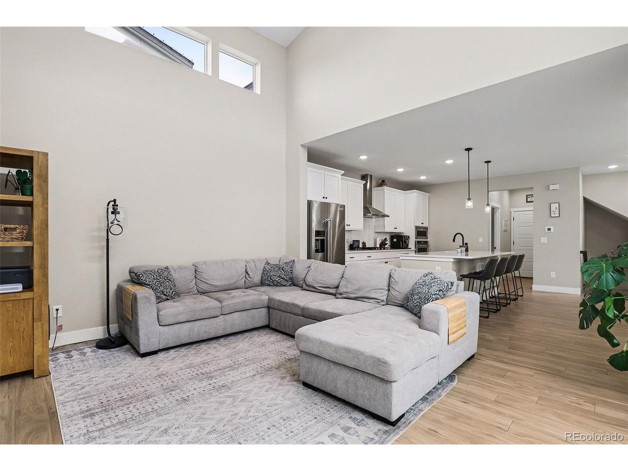 9958 East 63rd Place, Unit 2 Denver, CO 80238 - Photo 8 of 35 a living room with furniture and a dining table with wooden floor