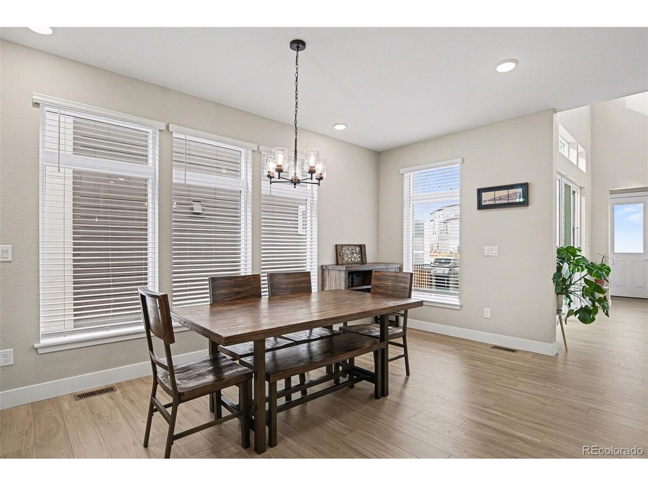 9958 East 63rd Place, Unit 2 Denver, CO 80238 - Photo 9 of 35 a dining room with furniture potted plants and wooden floor