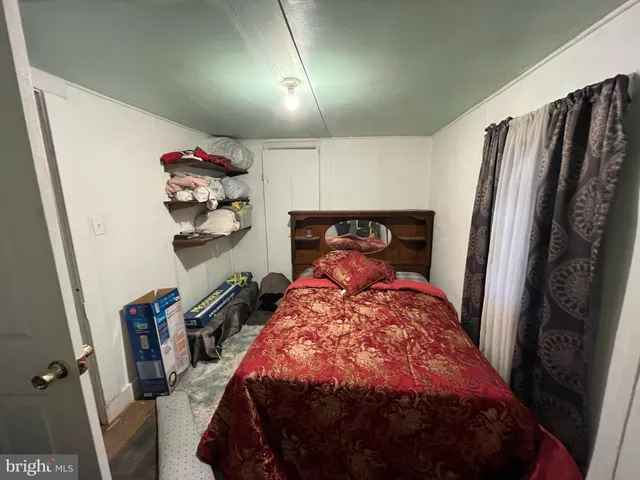 a bed sitting in a bedroom next to a cabinet