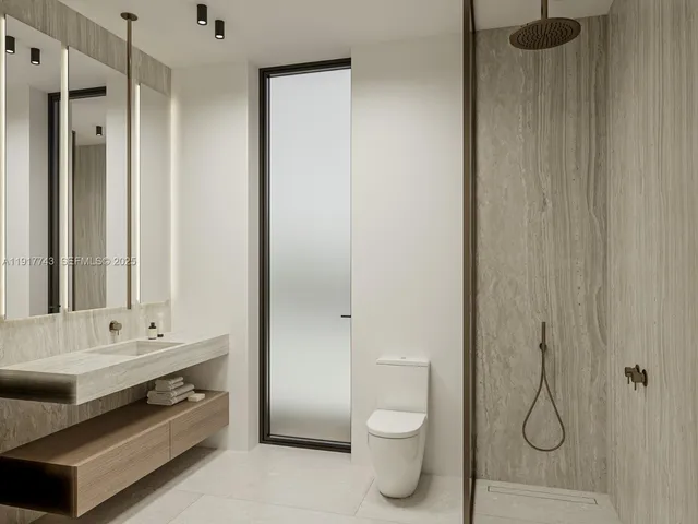 a bathroom with a toilet sink and shower